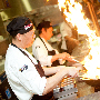 Thumbnail photo demonstrating UMass Dining Services, showing 4 chefs in a dining hall.